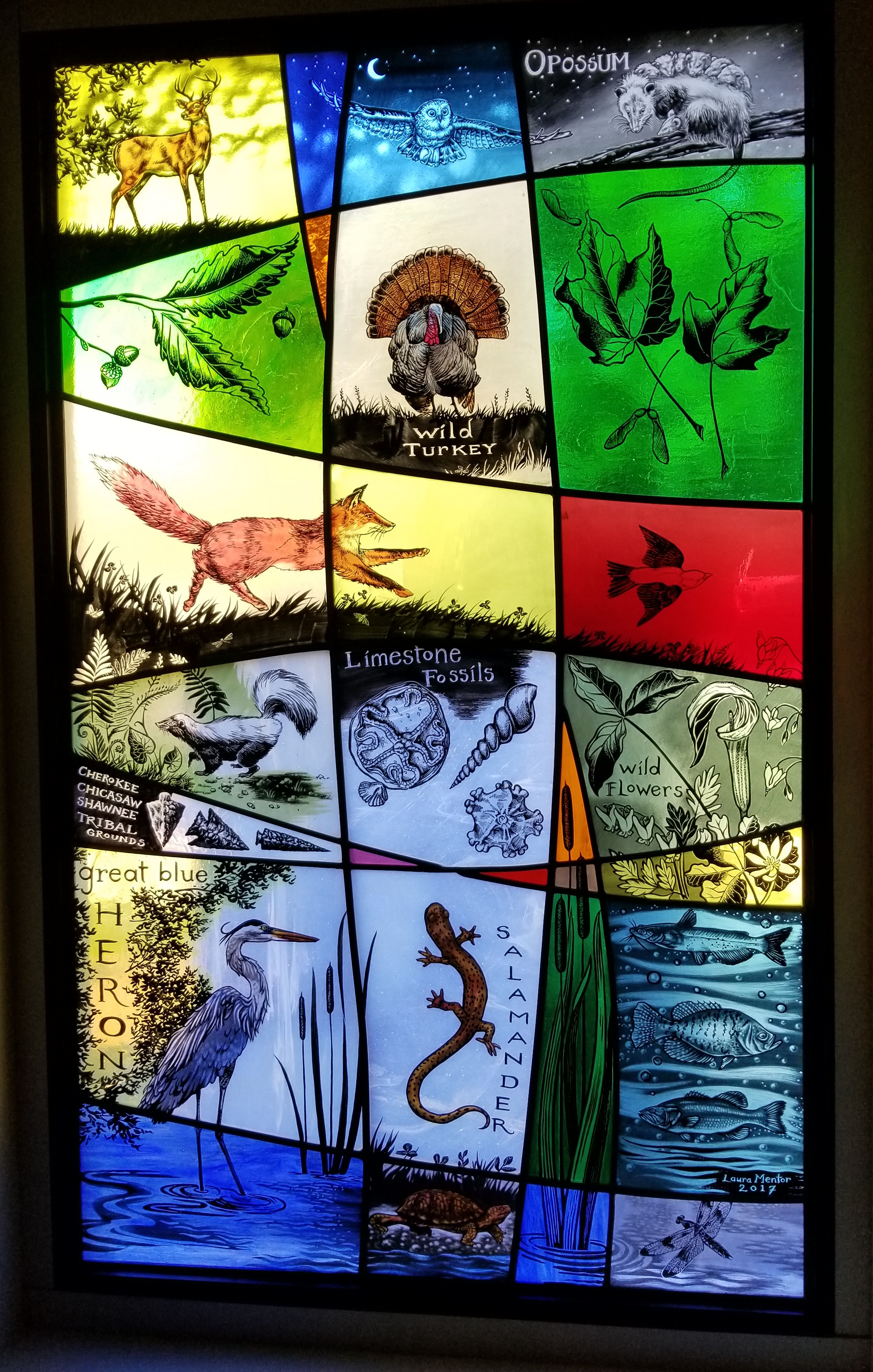 Second Stained Glass Window depicting animals from the lake and local creeks, the woods, and the history of the area through fossils