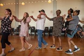 People in a line dancing together.