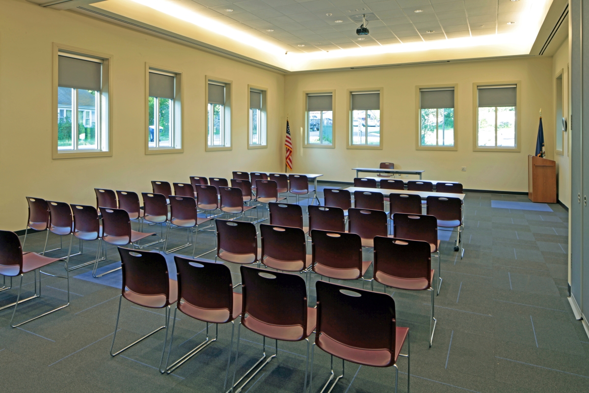 Includes six-foot tables, a ceiling mounted screen and data projector, flat screen for screen casting or HDMI laptop connection. Located adjacent to galley kitchen with refrigerator, sink and microwave. ($25 deposit if kitchen is used). May be divided into two smaller spaces by means of sliding doors to accommodate 2 groups with a maximum occupancy of109.