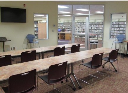 Small room includes four tables and 20 chairs for multiple configurations and flat screen for screen casting or HDMI laptop connection.