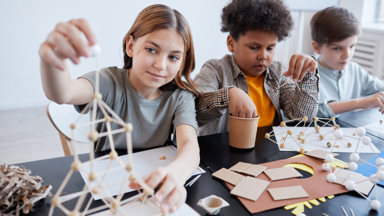 Tweens work together to build a structure.