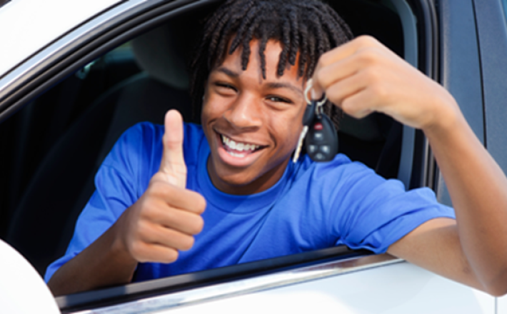 Teen male smiling with a thumbs up and holding keys